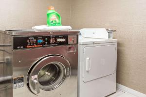 a washing machine with a green bottle on top of it at Baymont by Wyndham Lancaster in Lancaster