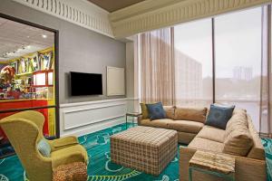 a living room with a couch and a tv at Wyndham Lake Buena Vista Resort Disney Springs® Resort Area in Orlando