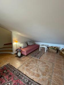 a bedroom with a pink bed in a room at Casa Via Vigo in Acireale