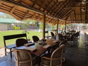 a group of tables and chairs under a pavilion at Buffalo Hotel in Hectorspruit