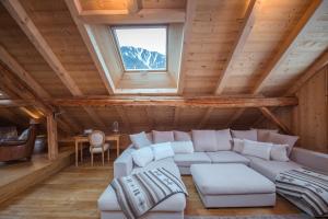 a living room with a couch and a window at Paccard Locations Chamonix in Chamonix-Mont-Blanc