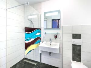 a bathroom with a sink and a mirror at ibis Styles Arnsberg Sauerland in Neheim-Hüsten