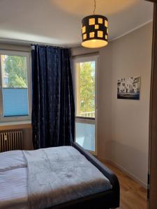 a bedroom with a bed and a large window at JBHotels Apartament Premium in Szczecin