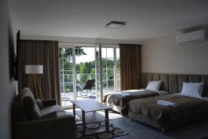 a hotel room with two beds and a couch at Przystanek Natura in Wola Gardzienicka