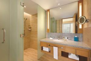 a bathroom with a sink and a mirror at JEN Singapore Orchardgateway by Shangri-La in Singapore