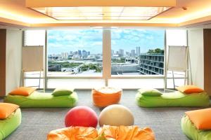 a room with a view of a city from a large window at JEN Singapore Orchardgateway by Shangri-La in Singapore
