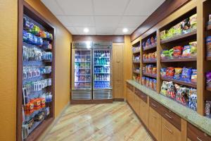 a grocery store aisle with drinks and food at La Quinta by Wyndham Houston Galleria Area in Houston