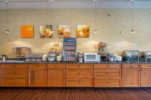 a kitchen with a stove top oven and a counter top at Comfort Suites Anchorage International Airport in Anchorage