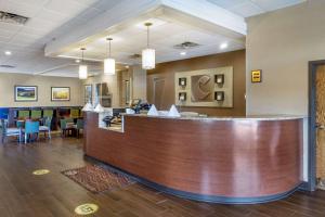 a lobby of a hotel with a bar and chairs at Comfort Inn & Suites near Danville Mall in Danville