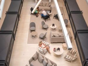 an overhead view of a living room with couches and tables at Mercure Hotel & Spa Bastia Biguglia in Biguglia