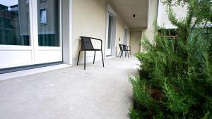 two chairs sitting on the porch of a house at Bern Youth Hostel in Bern