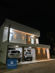 two cars parked in a garage at night at JH Flats in Maragogi