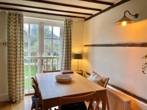 a dining room with a table and a window at The Writer's Cottage in Deal