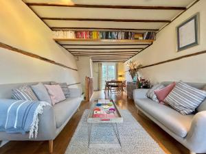 a living room with two couches and a table at The Writer's Cottage in Deal