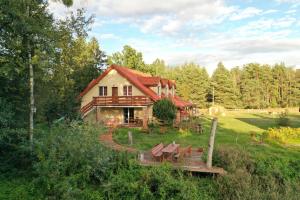 a log cabin in the middle of a forest at Rajski Staw in Zajki
