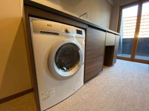 a washing machine in a cabinet in a room at C＆Jホテル in Tokyo