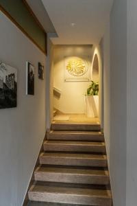 a hallway with stairs with a painting on the wall at Albergo Leon D'Oro in Maniago