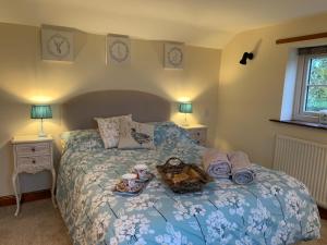 a bedroom with a bed with a tray of food on it at Farmhouse studio near Shrewsbury in Shrewsbury