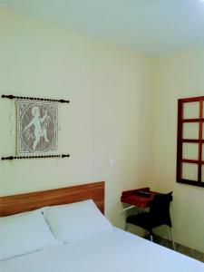 Кровать или кровати в номере Pousada Ouro do Vintem