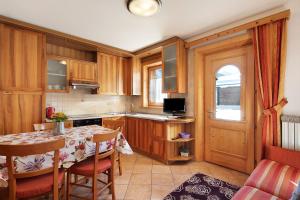 a kitchen with a table and a dining room at Baita sulle Alpi in Livigno