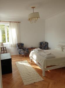 a bedroom with a bed and a table and chairs at Апартамент BOHO CHIC 2 Free parking in Varna City