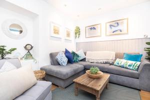 a living room with a couch and a table at Little Gem in Swanage
