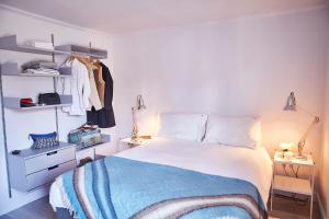 a bedroom with a bed with a blue blanket at SEALOFT Aldeburgh Air Manage Suffolk in Aldeburgh