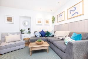 a living room with a couch and a table at Little Gem in Swanage