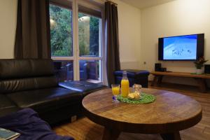 a living room with a coffee table and a couch at Ski House Szczyrk - Centrum in Szczyrk