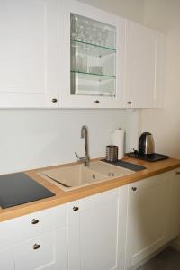 a kitchen with white cabinets and a sink at Przystanek Natura in Wola Gardzienicka +63 photos