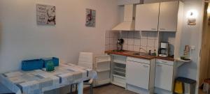 a kitchen with a table and a counter top at Fewo 514 in Tossens in Butjadingen OT Tossens