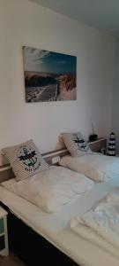 two beds in a bedroom with a picture on the wall at Fewo 514 in Tossens in Butjadingen OT Tossens