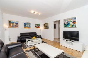 a living room with leather furniture and a flat screen tv at Apartment Iva 31 in Dubrovnik