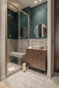 a bathroom with a sink and a shower at HIGHSTAY - Luxury Serviced Apartments - North Marais 1 in Paris
