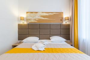 a bedroom with two towels on a bed at Hotel Element in Moscow