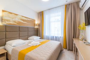 a hotel room with a bed with a laptop on it at Hotel Element in Moscow