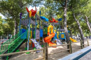 a playground with a slide in a park at Villaggio Baia Del Monaco in Manfredonia