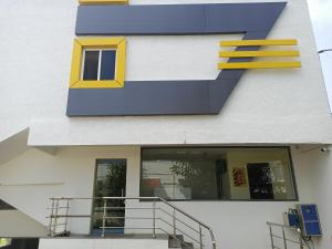 a building with a blue and yellow design on it at Purple Inn in Coimbatore
