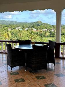 a table and chairs in a room with a view at Park View Apartment in Dunfermline