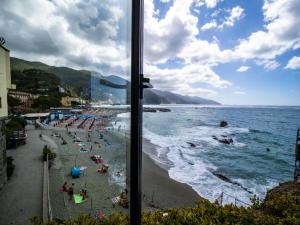 a view of a beach from a window at La Casa del Gigante Luxury Collection in Monterosso al Mare