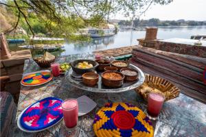 a table topped with plates of food and drinks at Anakato Nubian Experience in Aswan