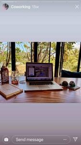 a laptop computer sitting on top of a wooden desk at Cookies Salad Resort in Salad Beach