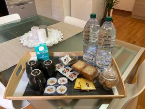 a tray with two bottles of water on a table at CASA BARTOLINI in Bologna