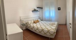 a small bedroom with a bed and a window at CASA BARTOLINI in Bologna