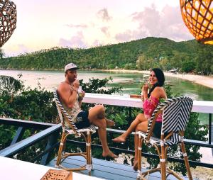 a man and a woman sitting on a boat at Cookies Salad Resort in Salad Beach