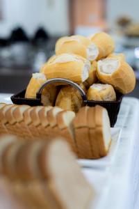 a basket of loaves of bread on a table at Hotel Monte Carlo in Dourados