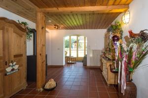 a kitchen with a wooden ceiling and a tile floor at Ferienhaus Am Steinbach in Ruhpolding