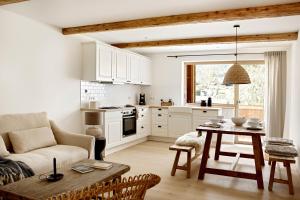 a kitchen and living room with a table and a couch at Der Schmiedhof in Bayrischzell