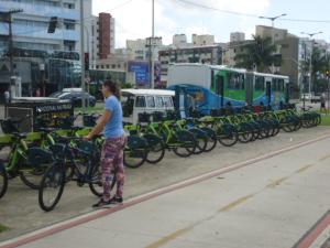 a woman standing next to a row of bikes at Solar da Praia in Vitória +40 photos