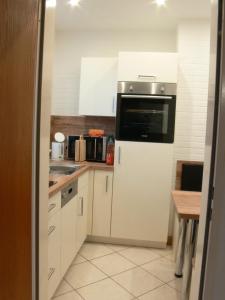 a kitchen with a white refrigerator and a sink at Bungalow 451 in Tossens in Butjadingen OT Tossens